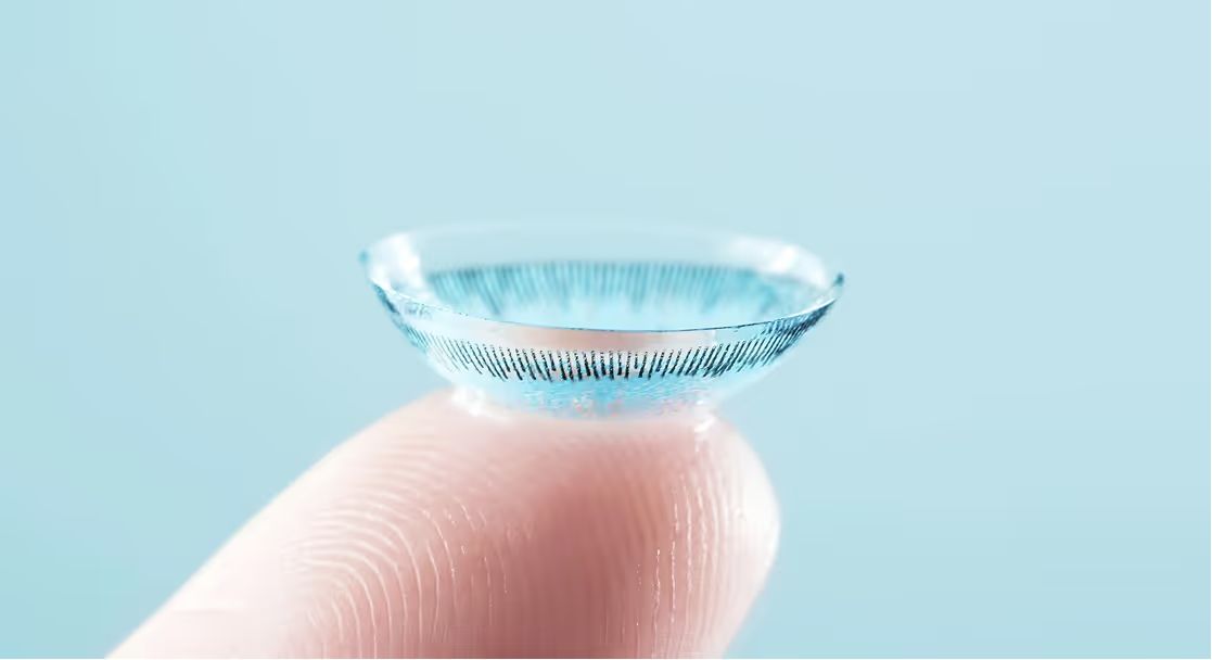 Contact lens balanced on a fingertip