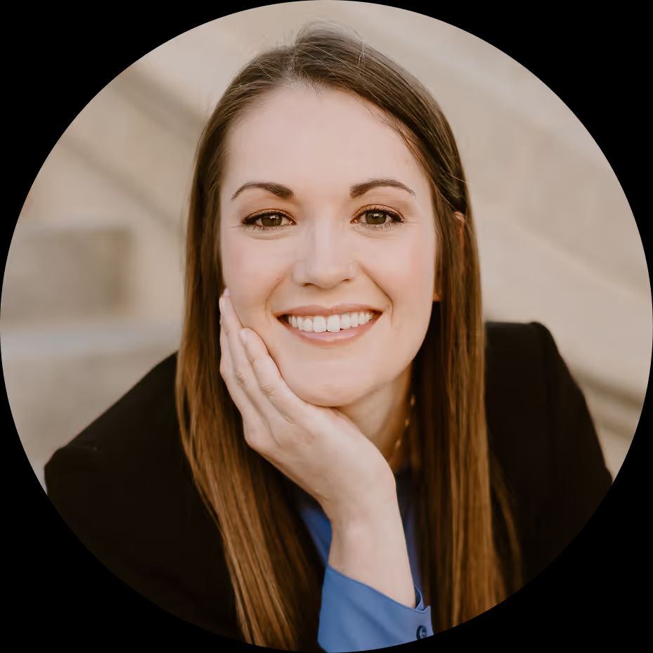 Dr. Heather Triggs, O.D., smiling with her chin resting on her hand