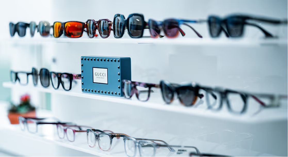 Shelves of eyeglass frames and sunglasses on display