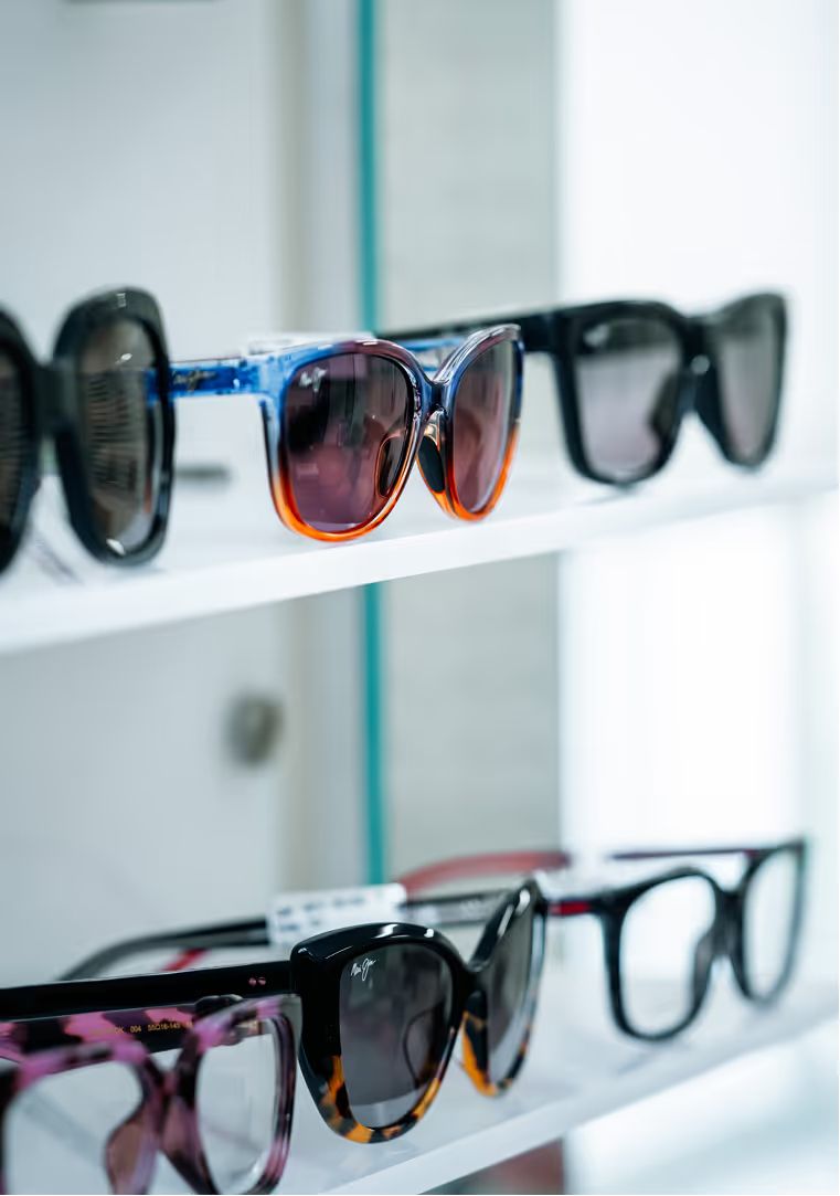 Sunglasses in several styles on white display shelves